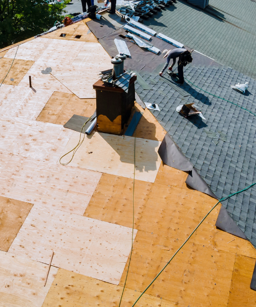 A group of men standing on top of a roof