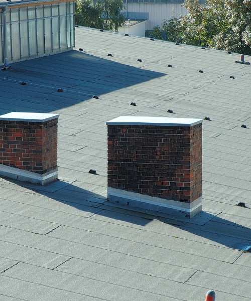 A couple of brick boxes sitting on top of a roof