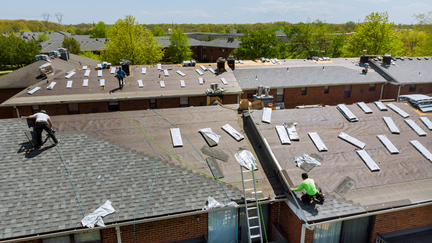 A group of men working on the roof of a building