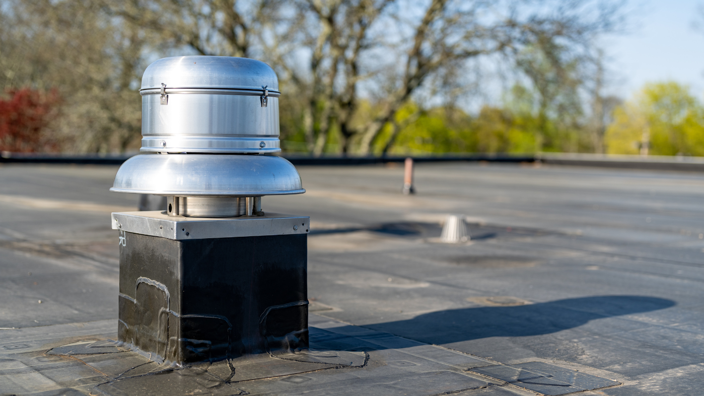 A metal box sitting on the side of a road