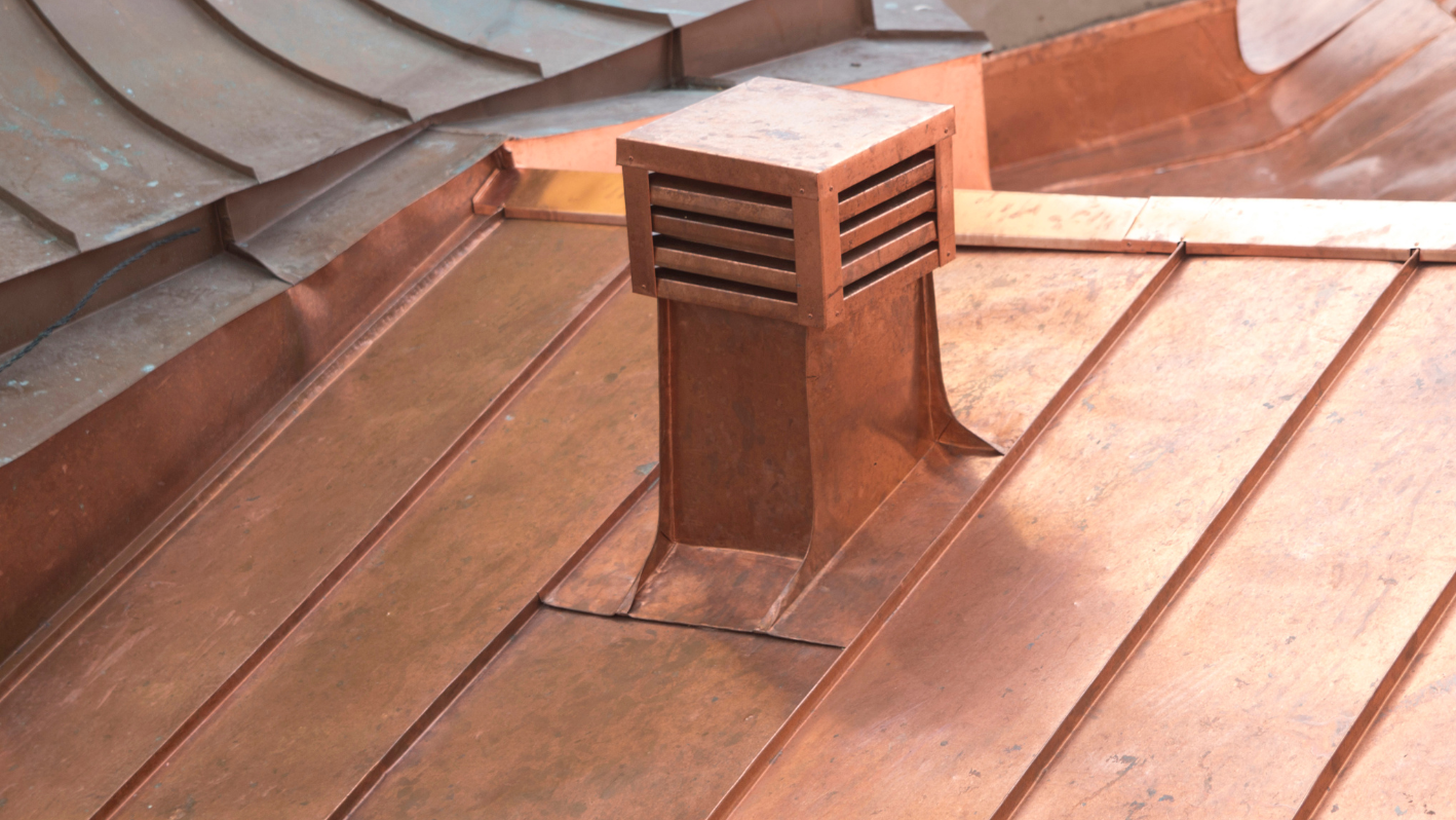 A wooden roof with a vent on top of it