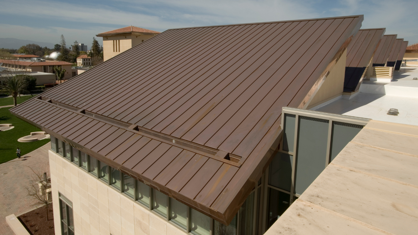 A brown roof on a building with a sky background